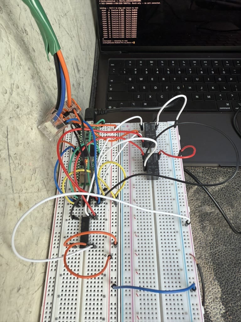 Breadboard with a Teensy microcontroller, digital potentiometer and relays, wired to a laptop